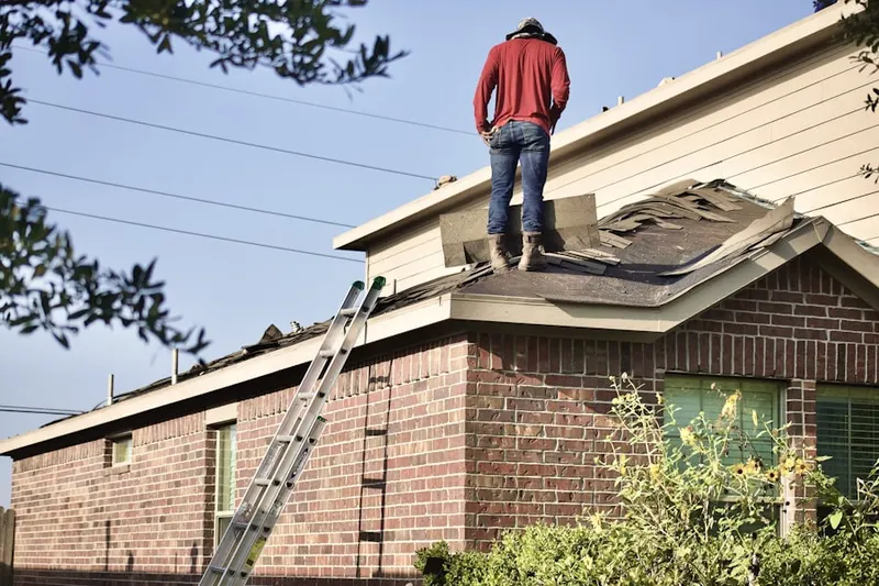 Professional roofer working on a residential roof in Muskegon